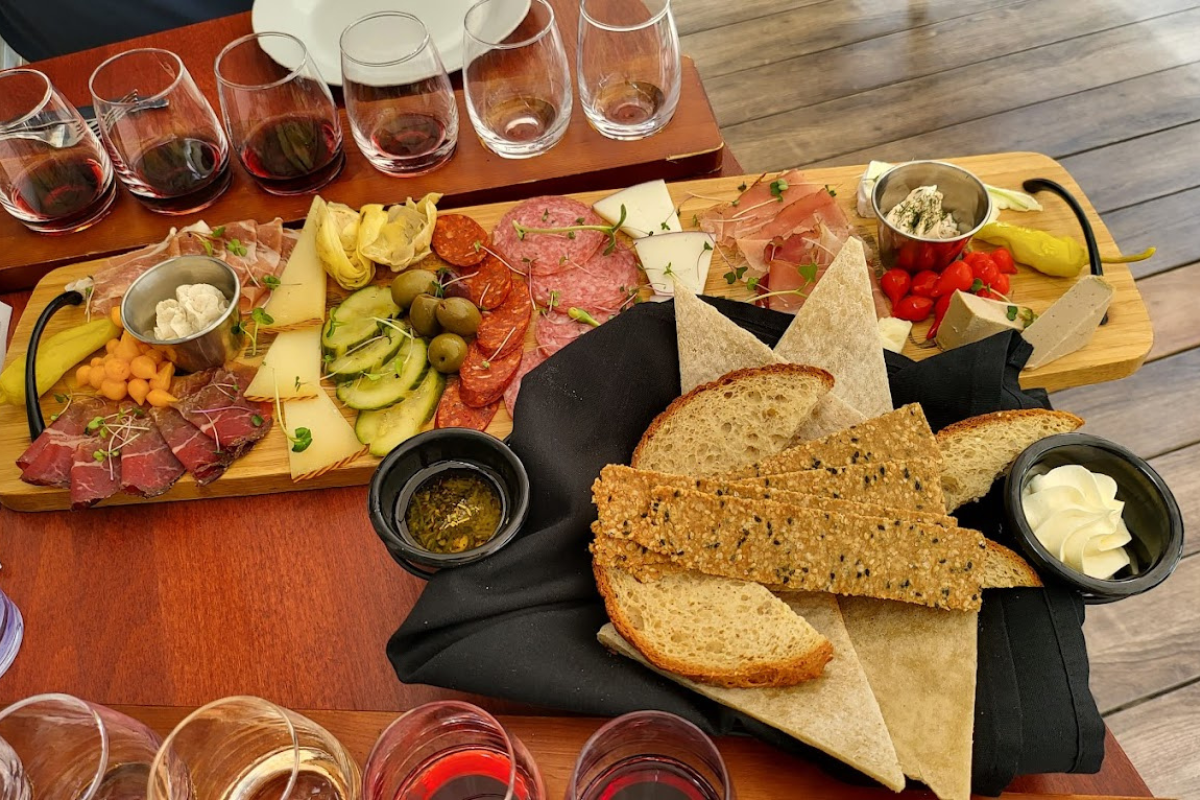 Charcuterie board and wine glasses at Aspen Peak Cellars