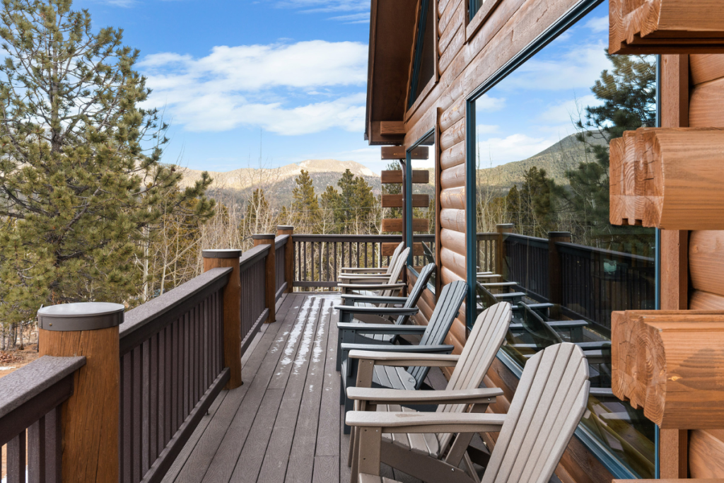 Adirondack chairs along the wraparound deck at Rosalie Ridge Cabin