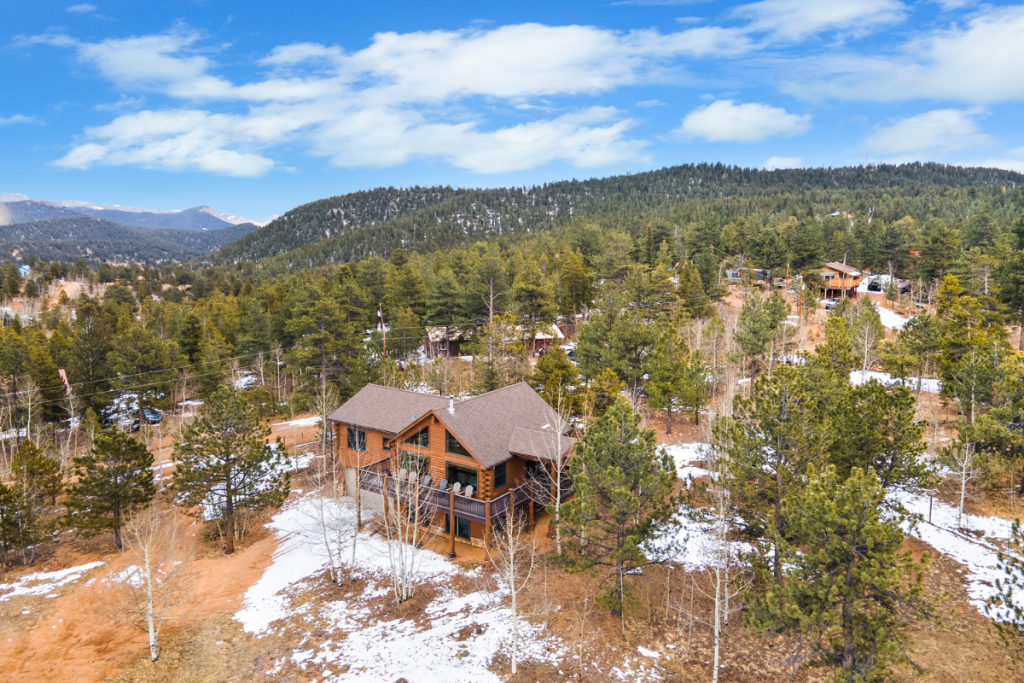 Aerial view of Rosalie Ridge Cabin surrounded by pine forest