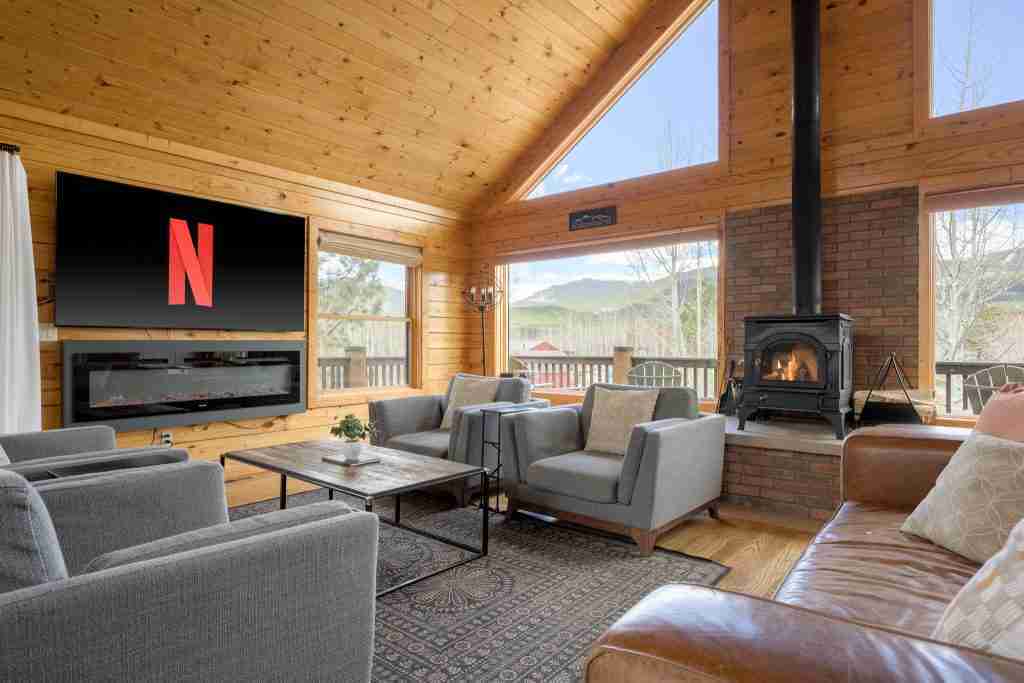 Smart TV above the electric fireplace in the great room, beside the wood stove