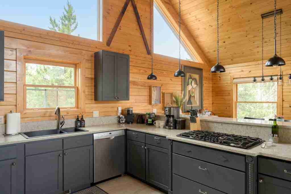 Kitchen counters with a gas range and pendant lights