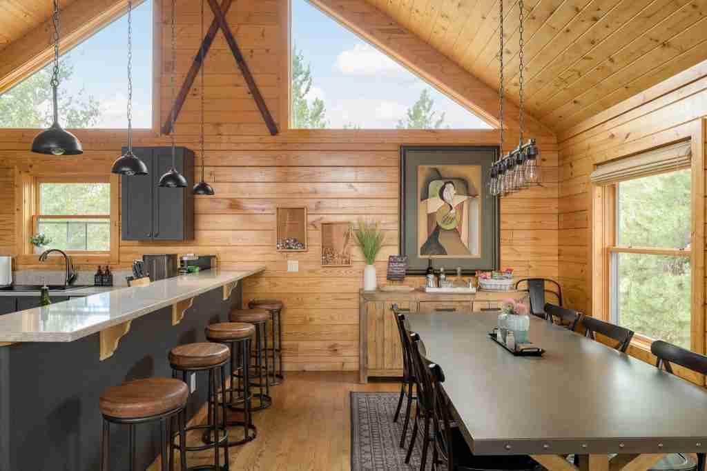 Breakfast bar stools and dining table under the vaulted ceiling