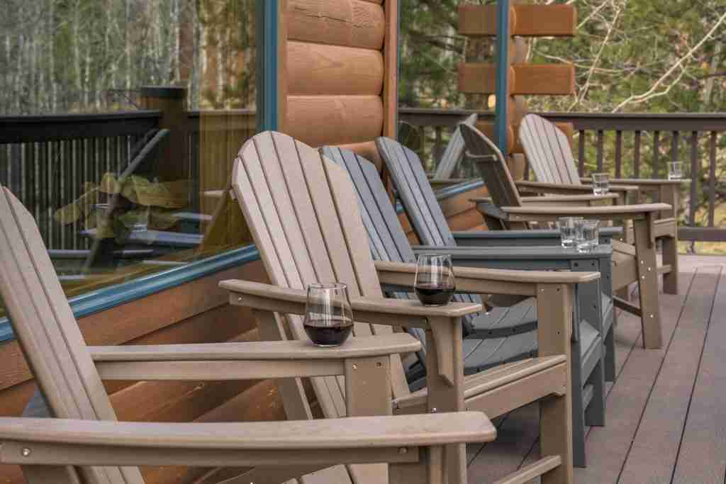 Row of Adirondack chairs on the covered wraparound deck