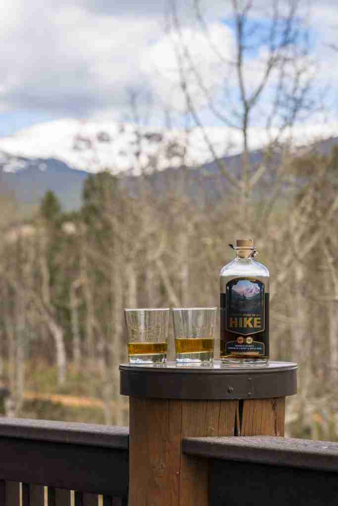 Drinks on the deck railing, overlooking the aspens and distant peaks