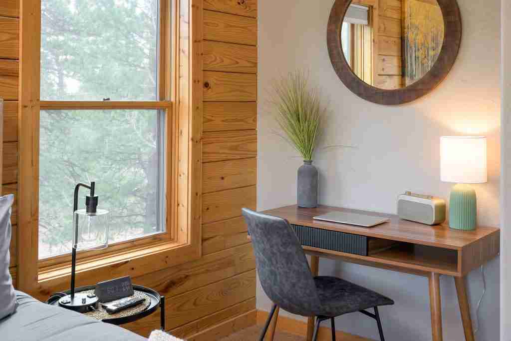 Dedicated workspace with a desk, chair, and lamp in the primary suite