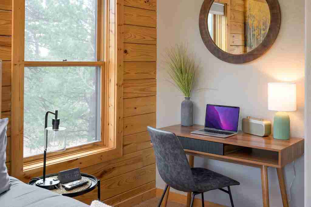 Dedicated workspace with a laptop and window views in the primary suite