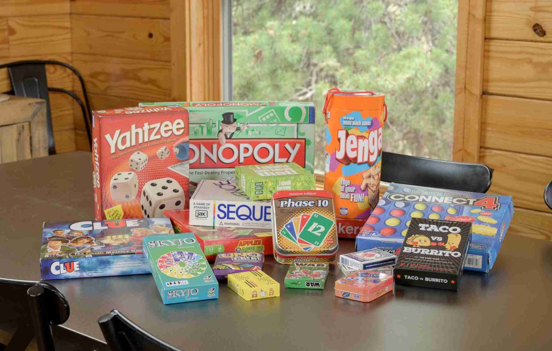 Stack of board games, including Yahtzee and Monopoly, on the dining table