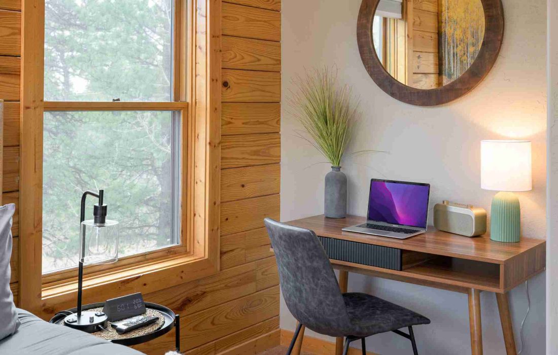 Dedicated workspace with a laptop and window views in the primary suite