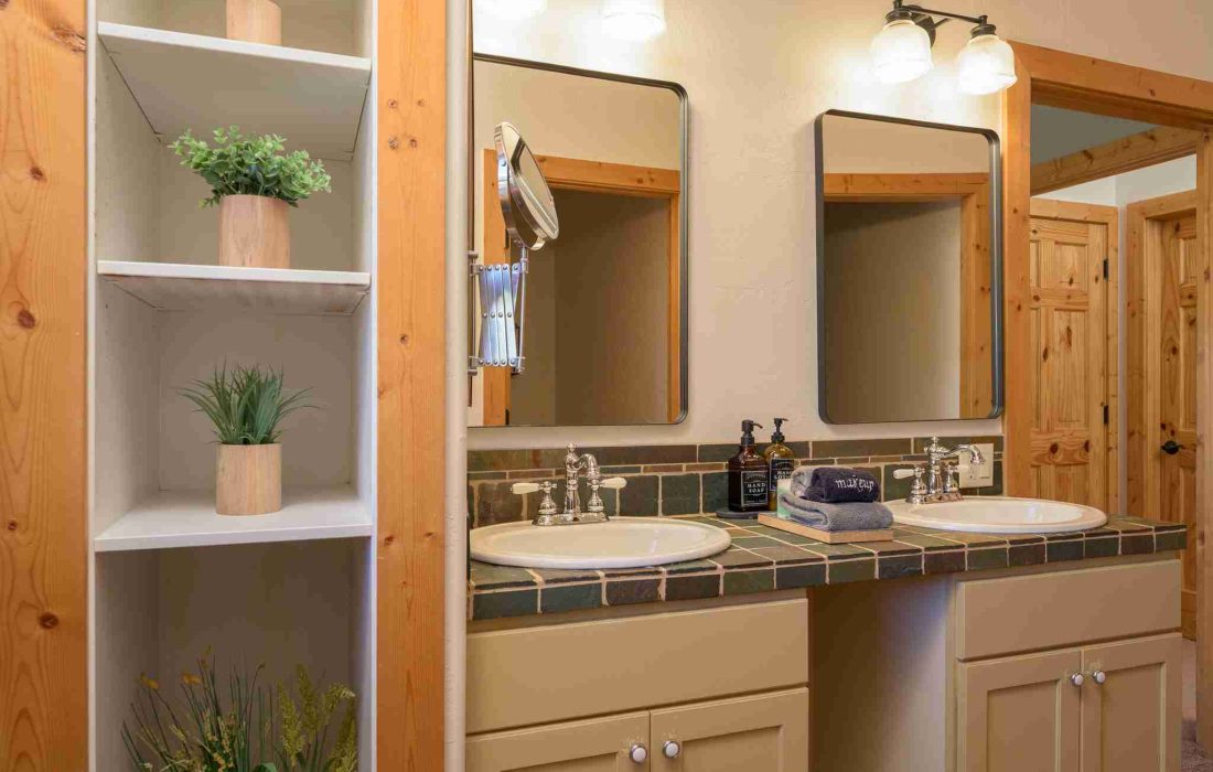Double vanity and open shelving in the primary suite bathroom